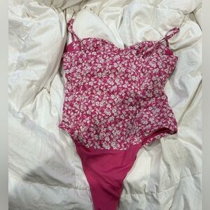 Pink sleeveless flowery body suit